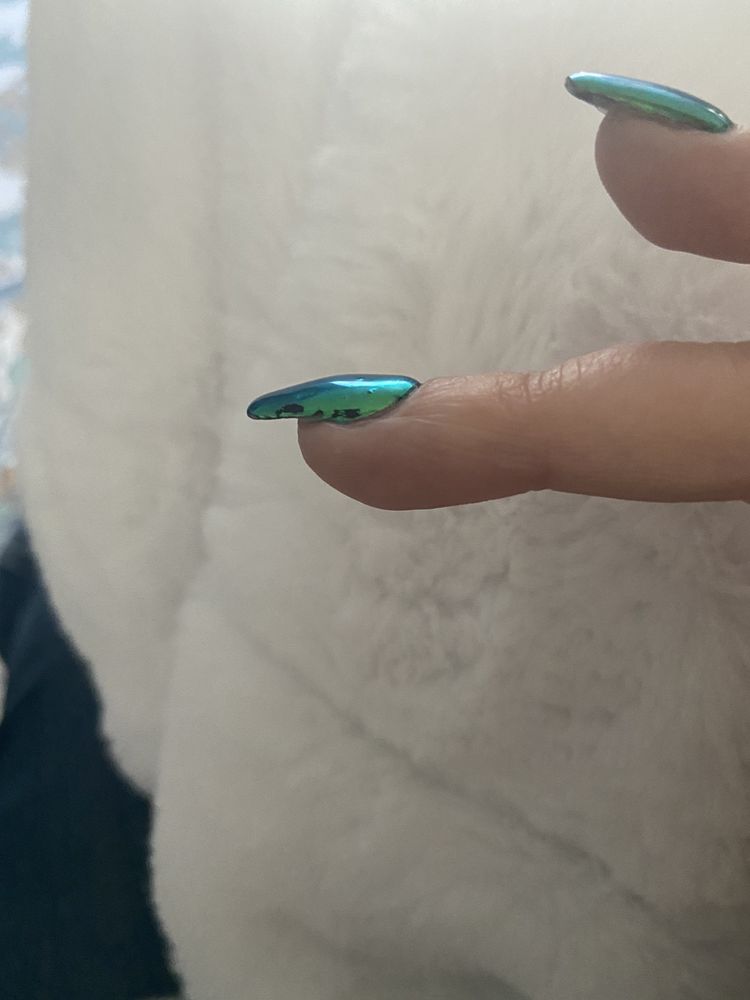 Macro detail of chrome green gel nail tip from T Nails & Spa, Seattle